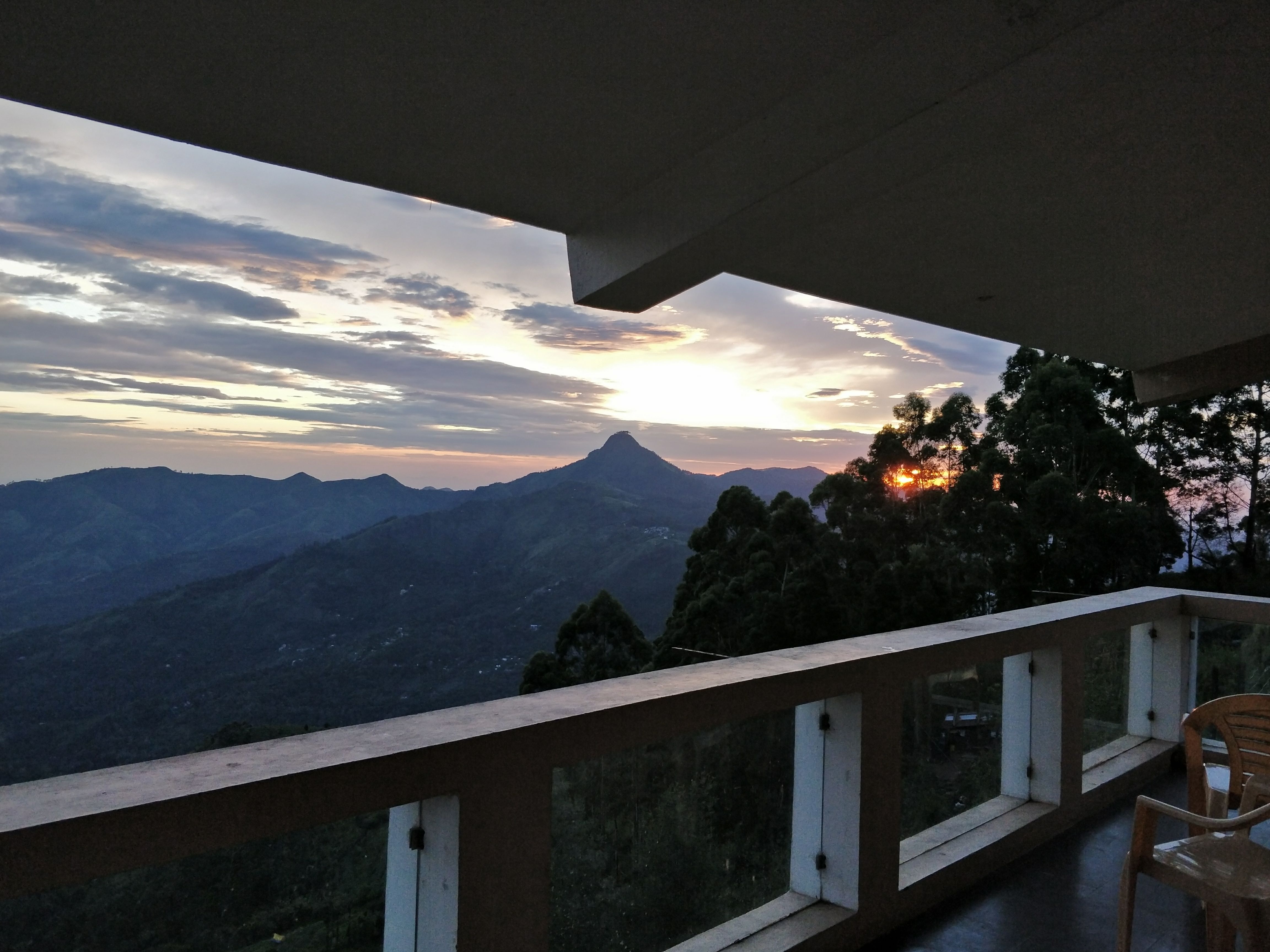 Sky,Mountain,Mountainous landforms,Cloud,Mountain range,House,Atmosphere,Architecture,Room,Sunlight