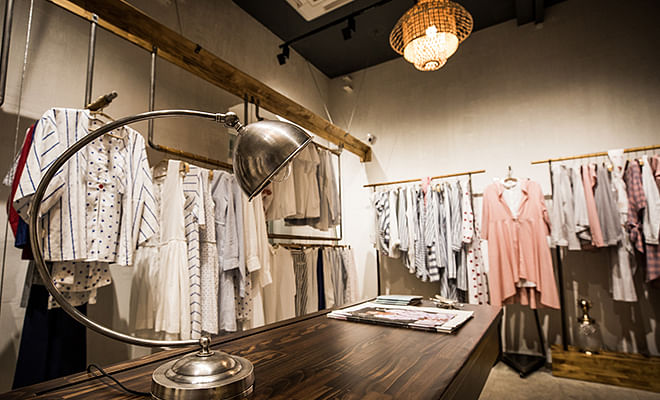 Lighting,Boutique,Interior design,Room,Light fixture,Ceiling,Building,Textile,Furniture,Dress