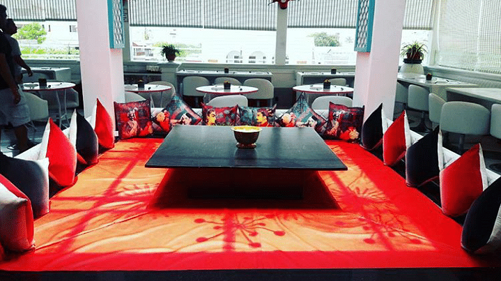 Restaurant,Red,Table,Room,Tablecloth,Interior design,Furniture,Textile,Meal,Flooring