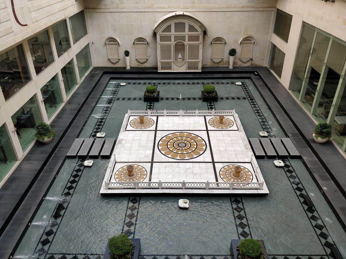 Courtyard,Architecture,Games,Symmetry,Building,Room,Daylighting,Interior design,Floor,Tile