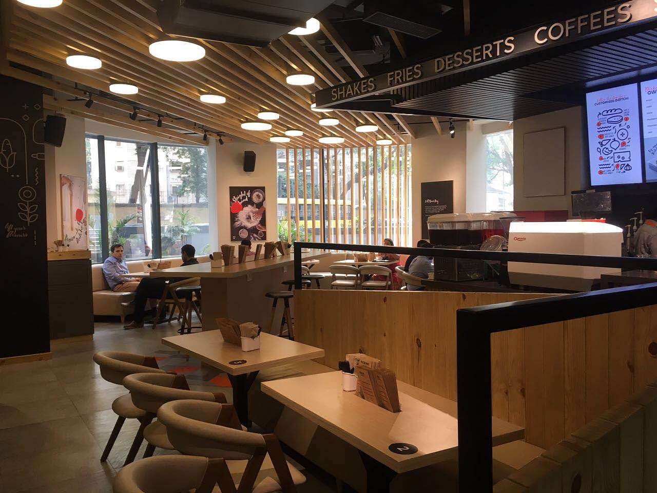 Building,Interior design,Room,Table,Furniture,Café,Restaurant,Coffeehouse,Architecture,Beam
