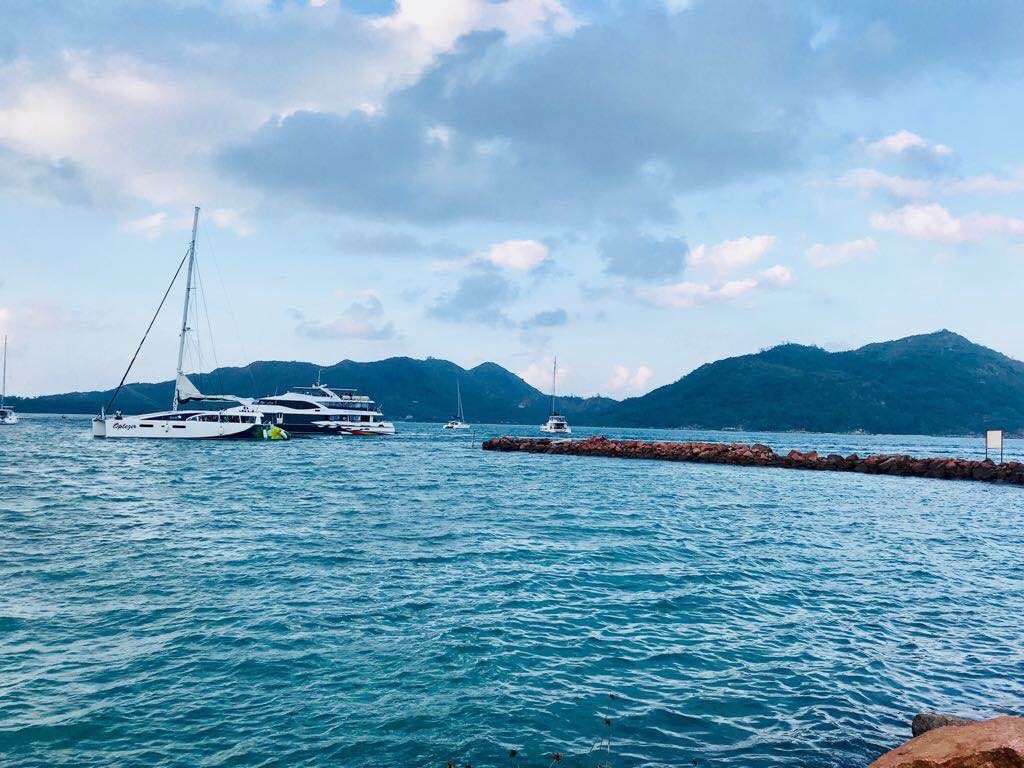 Sky,Body of water,Sea,Blue,Ocean,Boat,Water,Cloud,Mountain,Vehicle