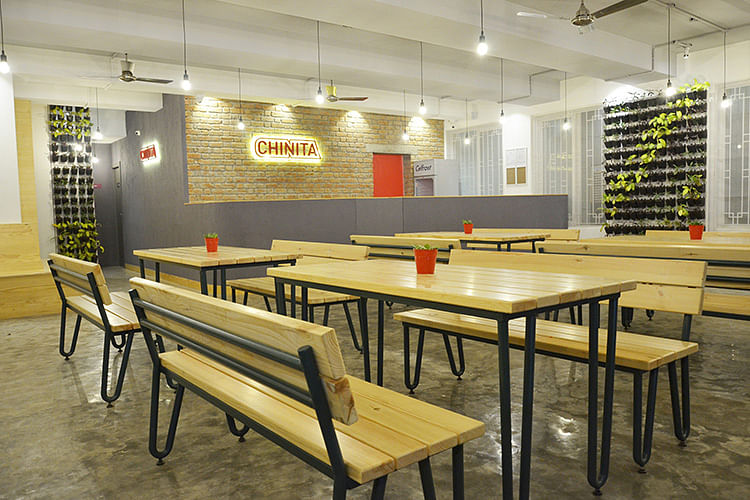 Room,Interior design,Furniture,Table,Building,Cafeteria,Yellow,Restaurant,Architecture,Dining room