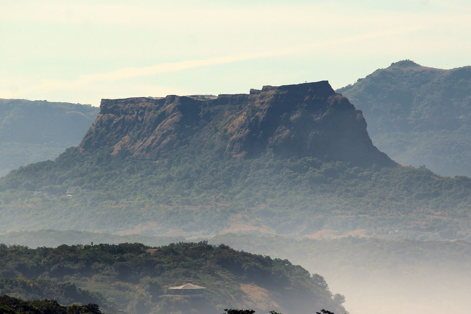 Mountainous landforms,Mountain,Sky,Highland,Mountain range,Atmospheric phenomenon,Ridge,Hill,Natural landscape,Cloud