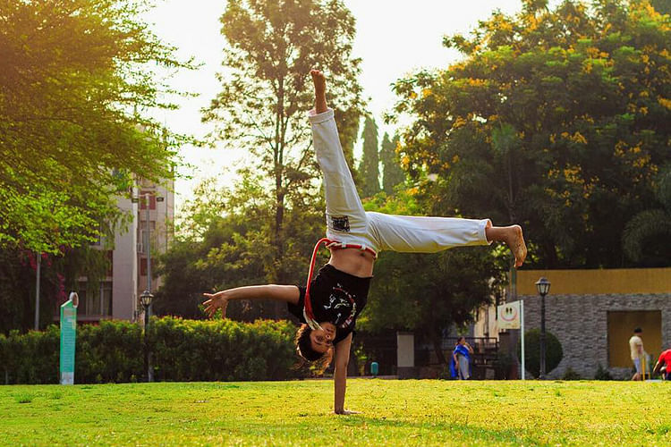 Green,Tricking,Tree,Flip (acrobatic),Sky,Acrobatics,Grass,Plant,Performance,Balance