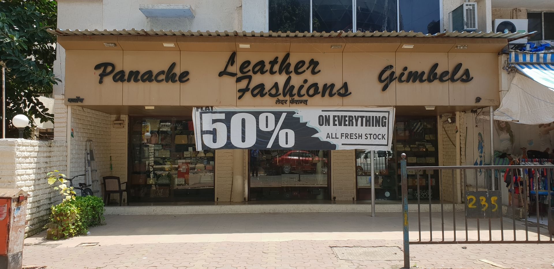 Building,Font,Art,Facade,Signage,Outlet store