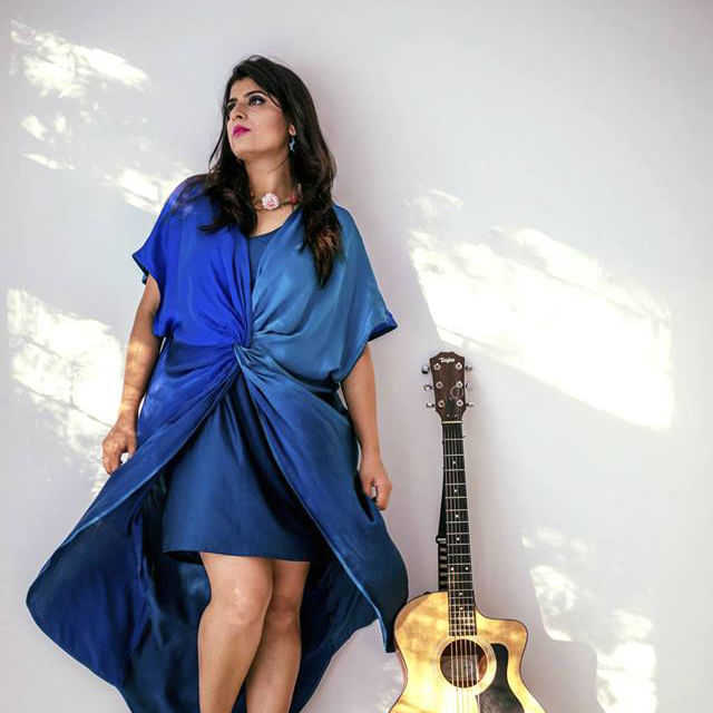 Blue,Guitar,String instrument,Photo shoot,String instrument,Musical instrument,Plucked string instruments,Musician,Fashion,Shoulder