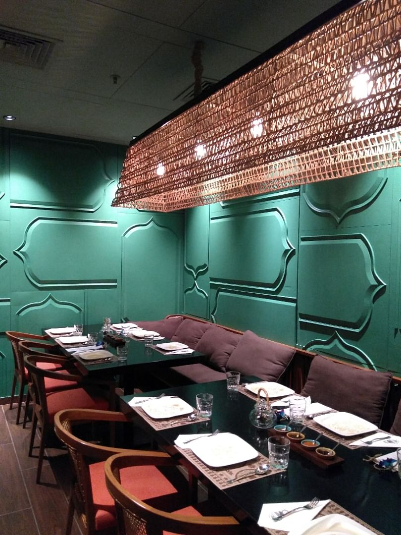 Green,Room,Restaurant,Turquoise,Lighting,Interior design,Wall,Ceiling,Building,Table