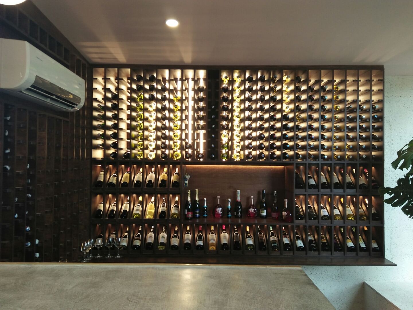 Wine cellar,Winery,Wine rack,Wine bottle,Wall,Architecture,Wine,Building,Interior design,Bottle