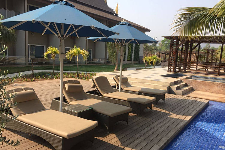 Umbrella,Property,Furniture,Patio,Shade,Outdoor furniture,Resort,Sunlounger,Outdoor table,Building