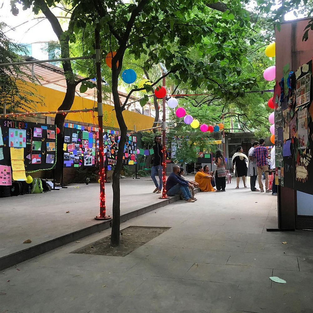 Street,Town,Neighbourhood,Public space,Tree,Urban area,Sidewalk,Infrastructure,Pedestrian,Art