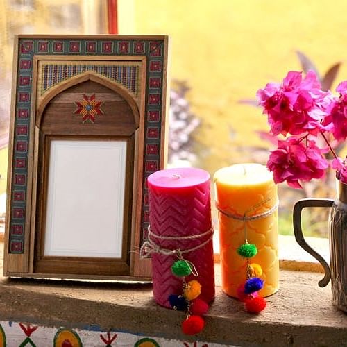 Candle,Lighting,Room,Floral design,Interior design,Plant,Flower,Window,Interior design,Picture frame