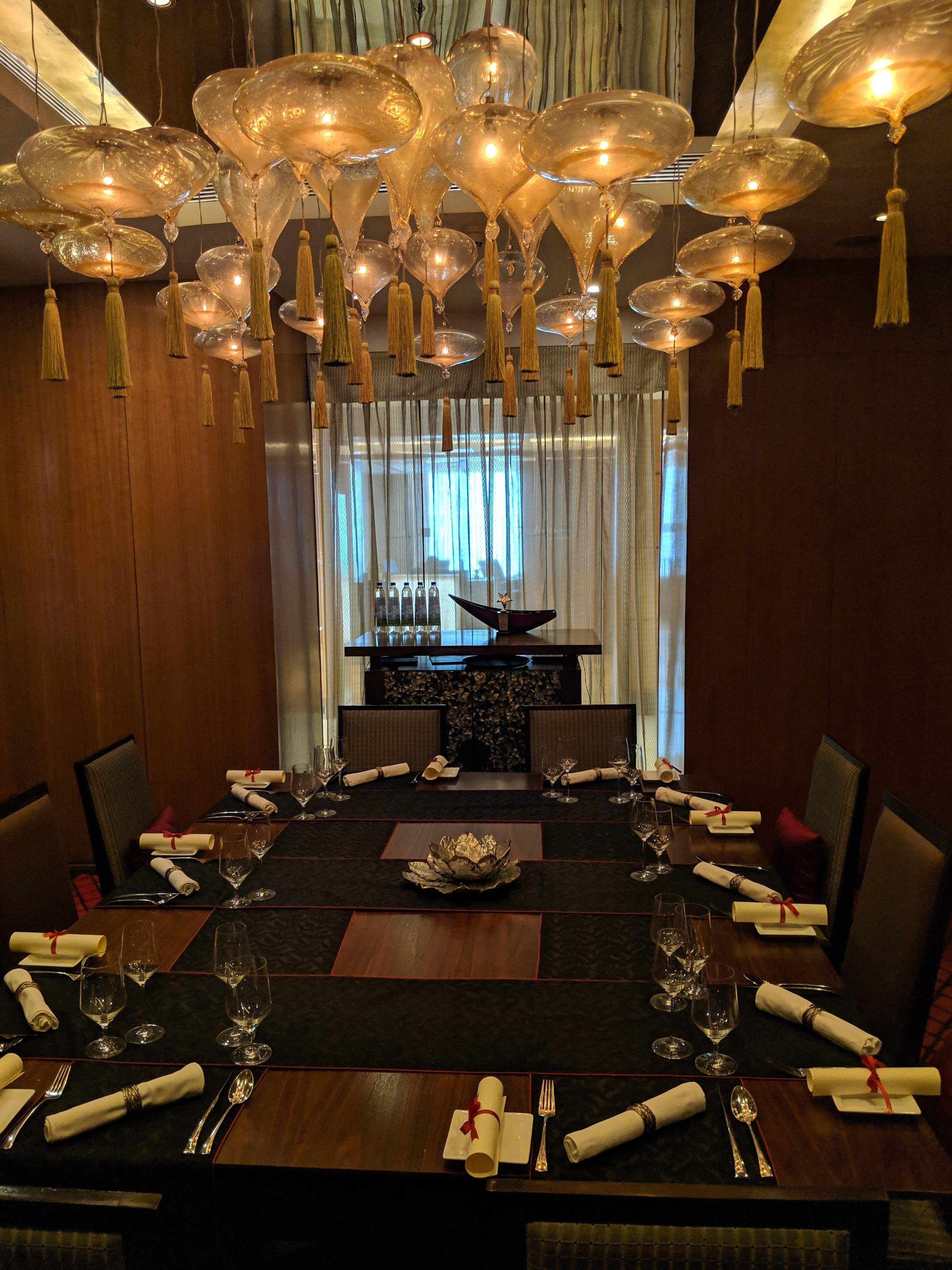 Lighting,Room,Restaurant,Light fixture,Ceiling,Interior design,Table,Chandelier,Centrepiece,Function hall