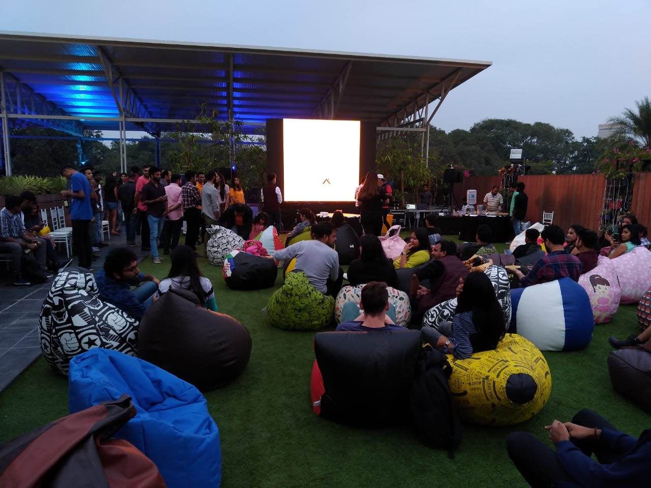 Crowd,Bean bag,Event,Leisure,Tree,Lawn,Night,Audience,Recreation,House