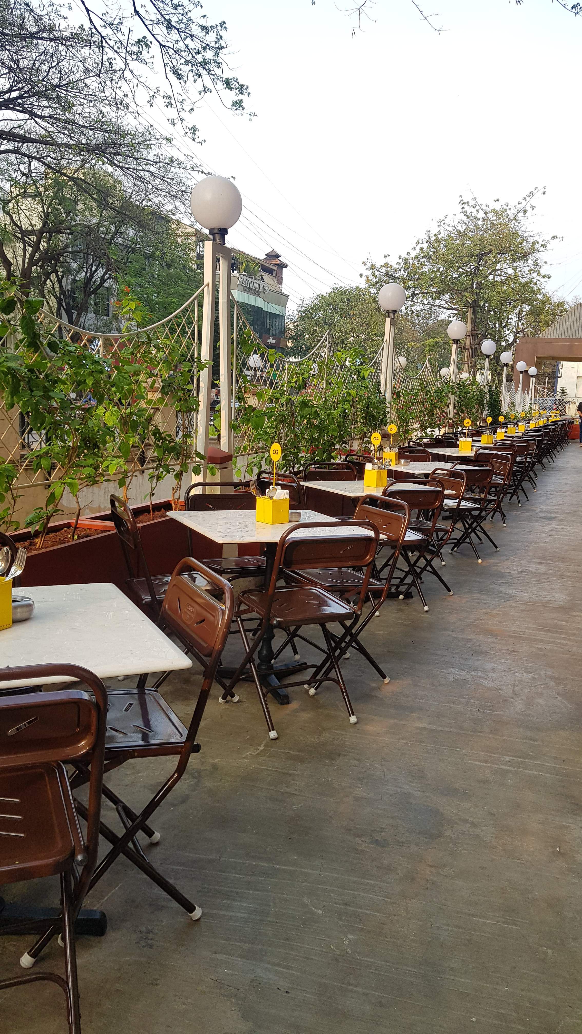 Property,Furniture,Table,Yellow,Restaurant,Chair,Real estate,Tree,Building,Architecture