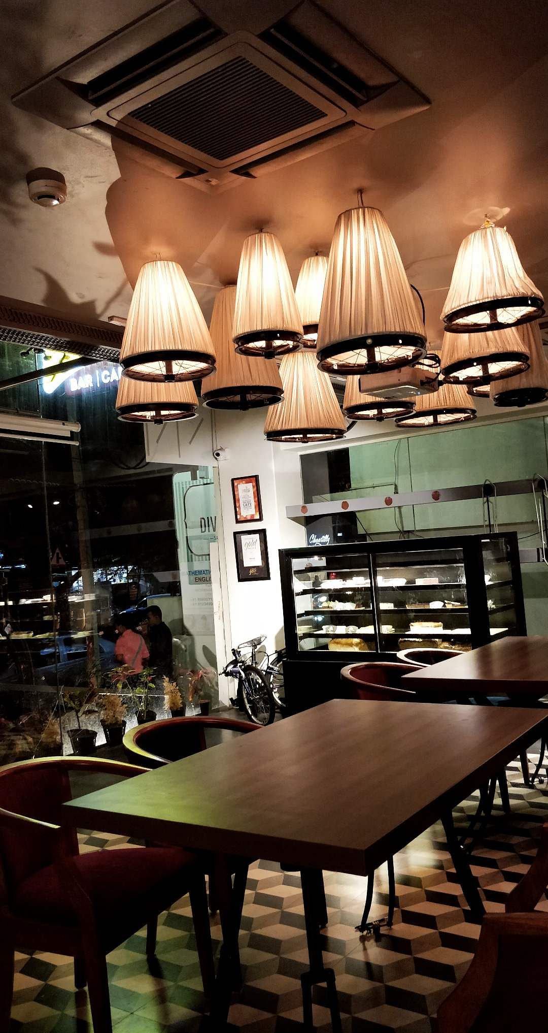 Restaurant,Lighting,Table,Room,Lighting accessory,Furniture,Interior design,Building,Light fixture,Café