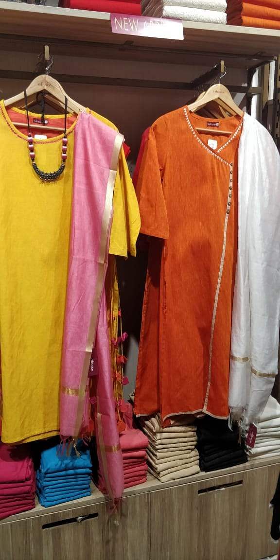 Clothing,Clothes hanger,Outerwear,Boutique,Yellow,Sleeve,T-shirt,Room,Textile,Jacket