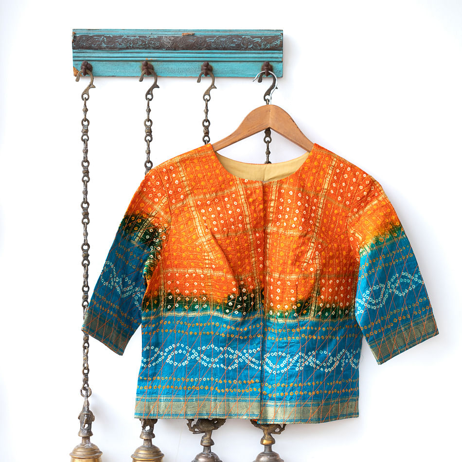 Clothing,Orange,Blue,Turquoise,Aqua,Outerwear,Sleeve,Neck,Clothes hanger,Blouse