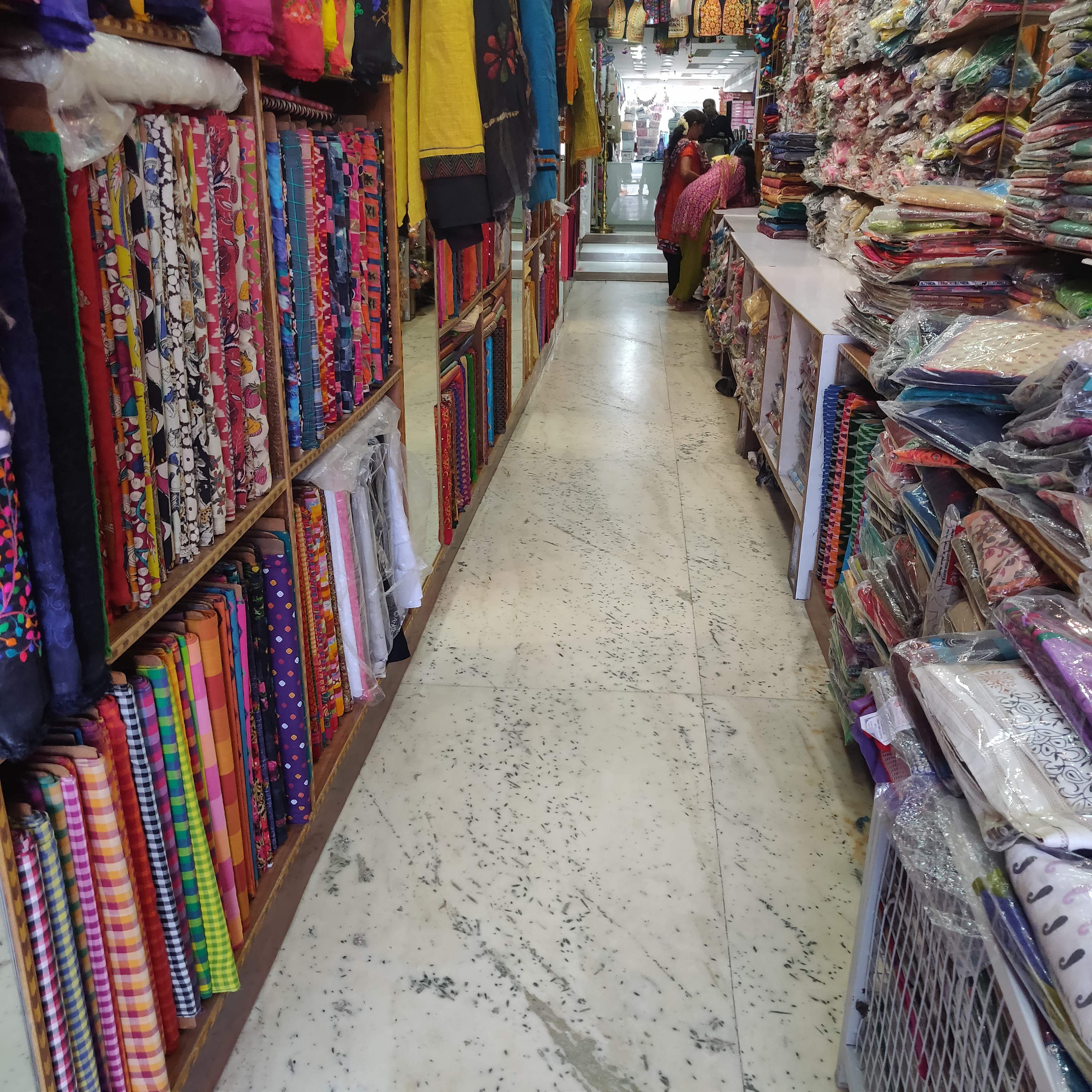 Aisle,Retail,Floor,Public space,Building,Textile,Bazaar,Marketplace,Flooring,Selling