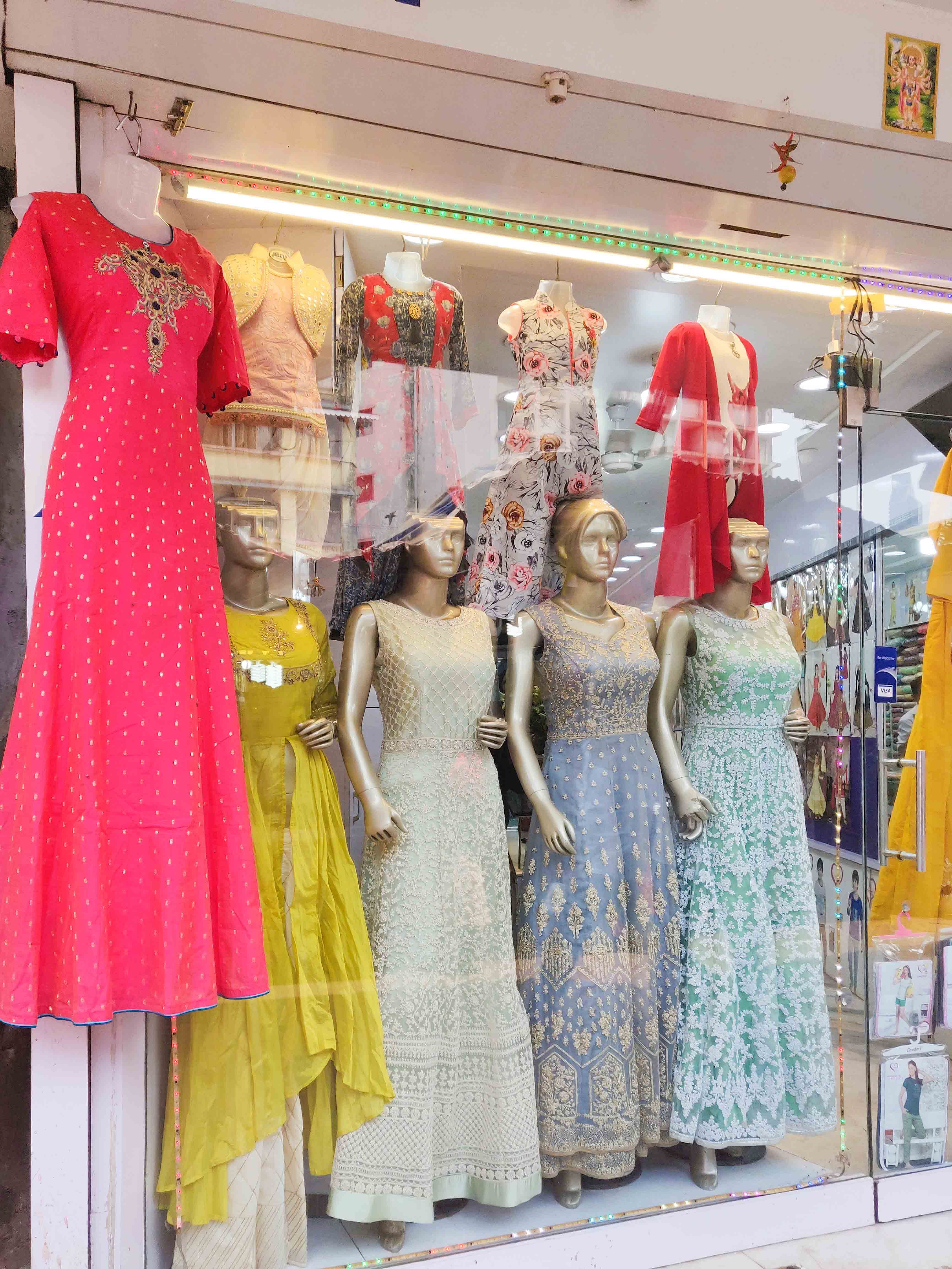 Boutique,Clothing,Dress,Pink,Mannequin,Fashion,Yellow,Fashion design,Display window,Formal wear