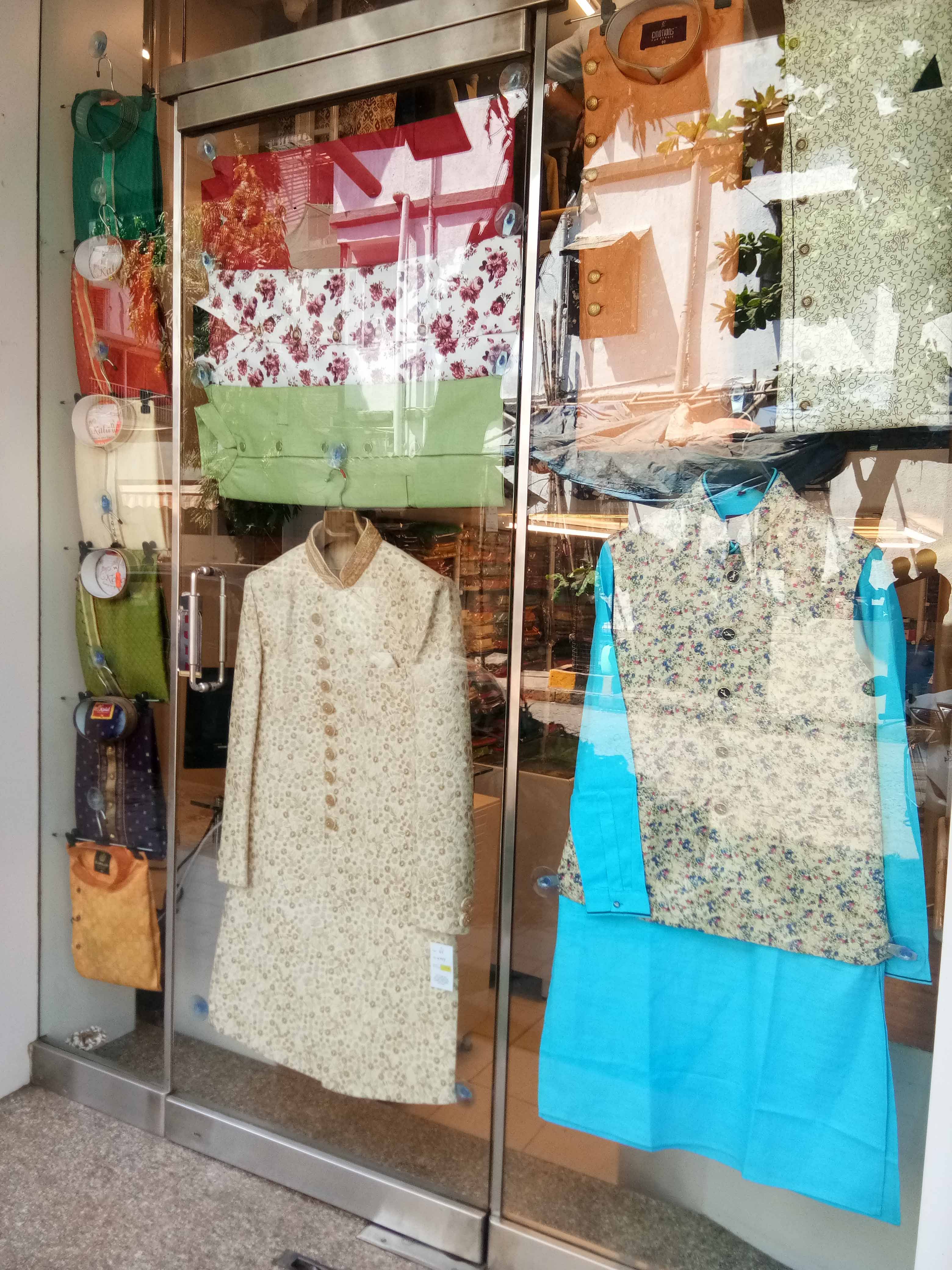 Green,Boutique,Fashion,Room,Clothes hanger,Display window,Textile,Door,T-shirt,Window