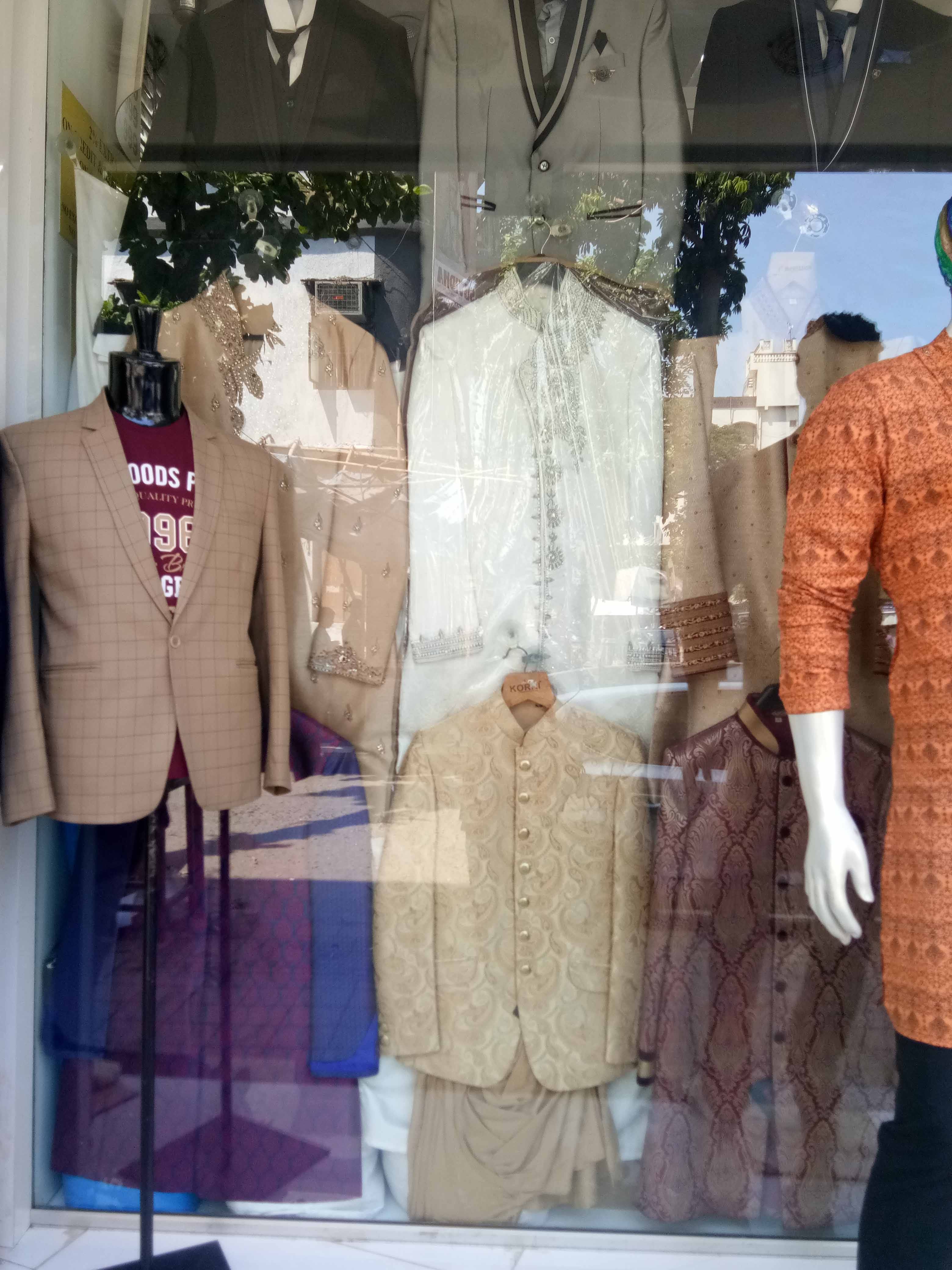 Clothing,Boutique,Display window,Mannequin,Fashion,Outerwear,Jacket,Dress,Suit,Window