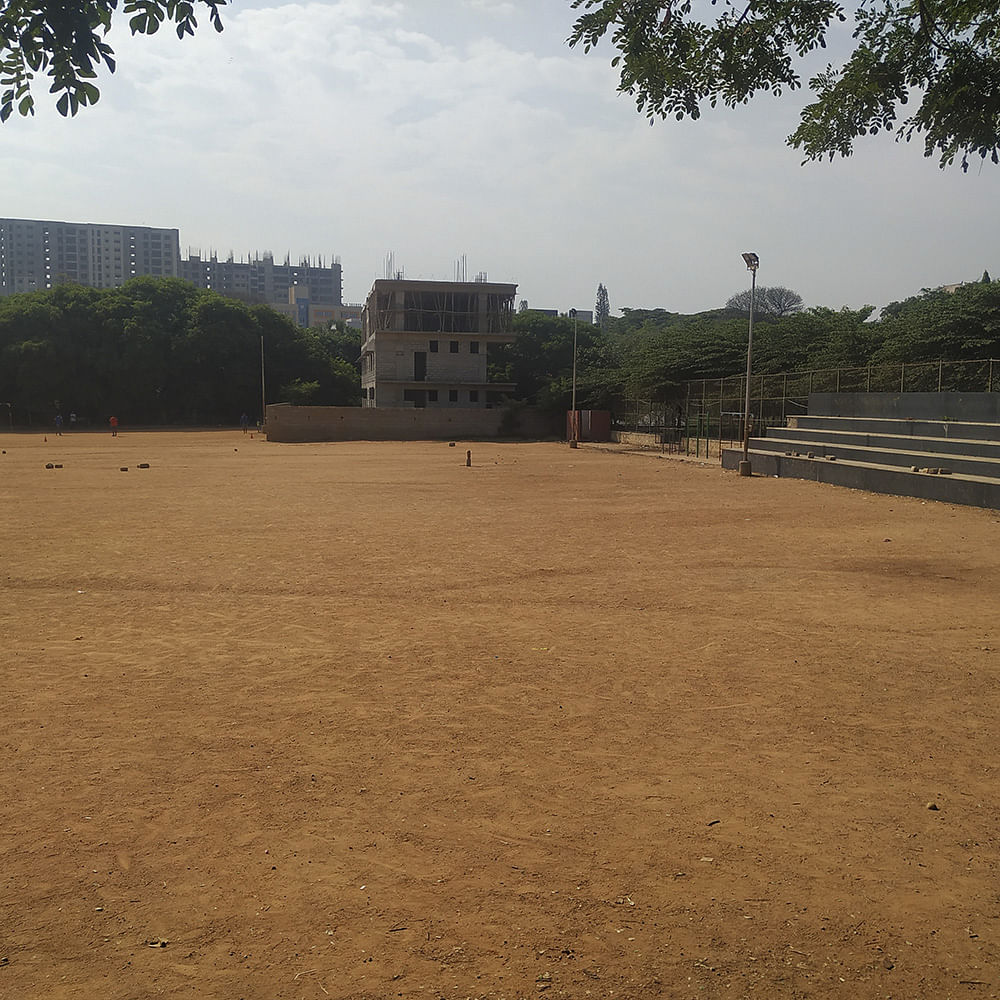 Sky,Soil,Grass,Land lot,Tree,Sport venue,Architecture,Cricket,Cloud,Landscape