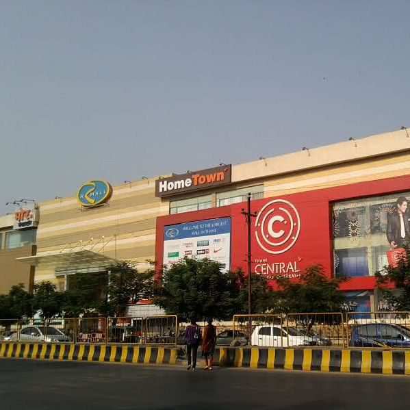 Sky,Transport,Building,Architecture,Tree,Facade,Shopping mall,Metropolitan area,Advertising,City