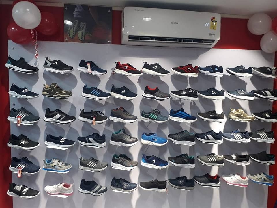 Shoe store,Footwear,Shoe,Display case,Eyewear,Room,Athletic shoe,Collection,Glasses,Shoe organizer