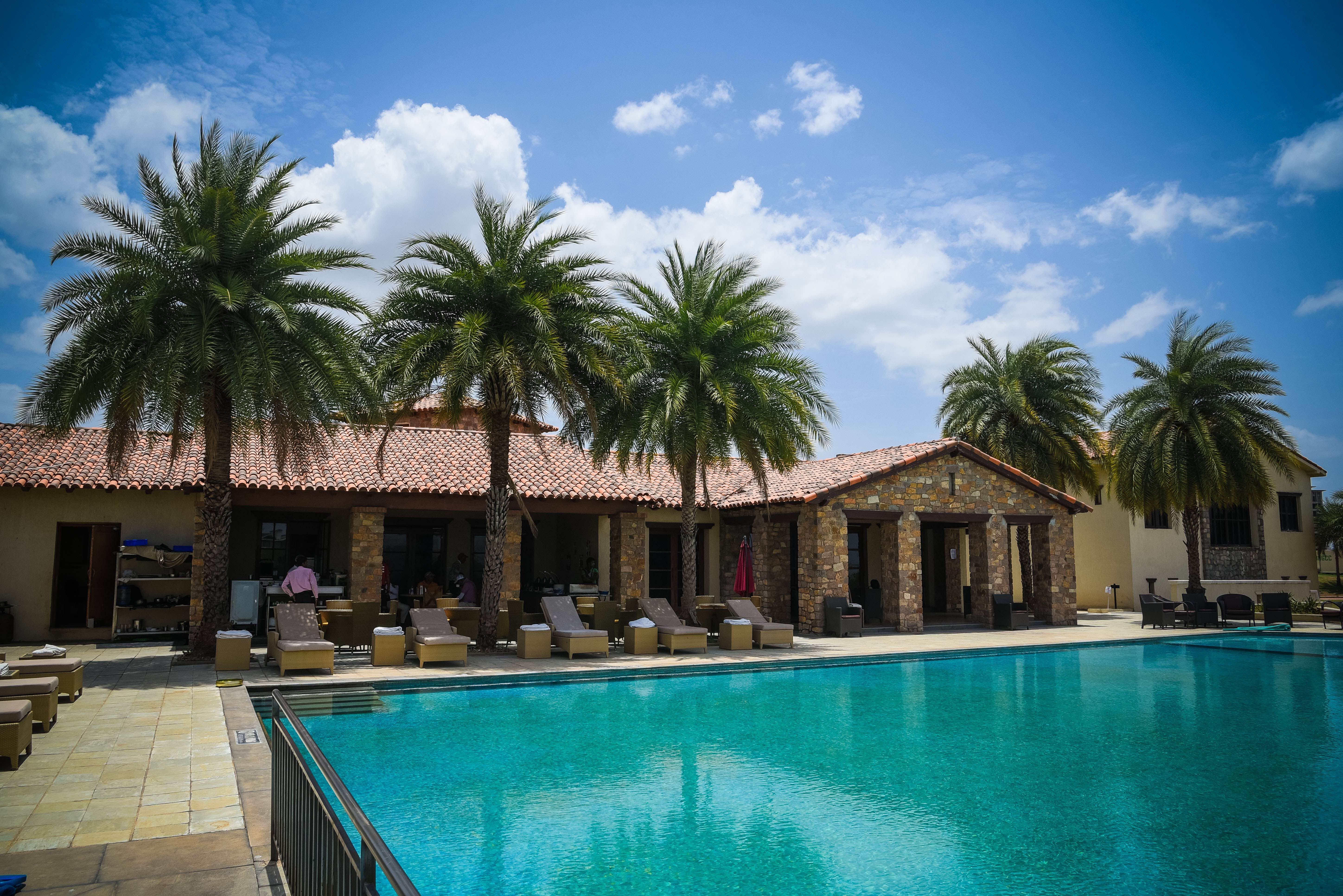 Swimming pool,Property,Resort,Building,Palm tree,Real estate,Tree,House,Vacation,Home