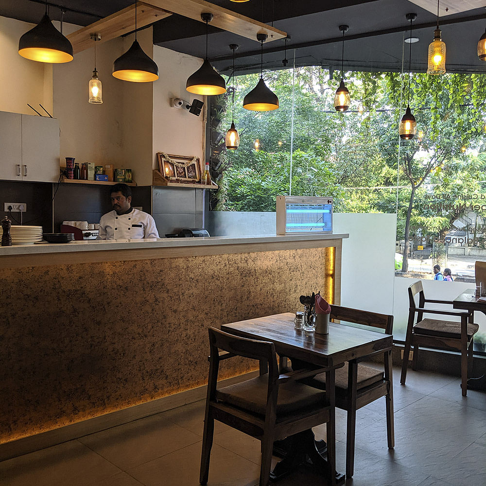 Room,Restaurant,Building,Interior design,Table,Furniture,Café,Coffeehouse,Cafeteria,Kitchen & dining room table