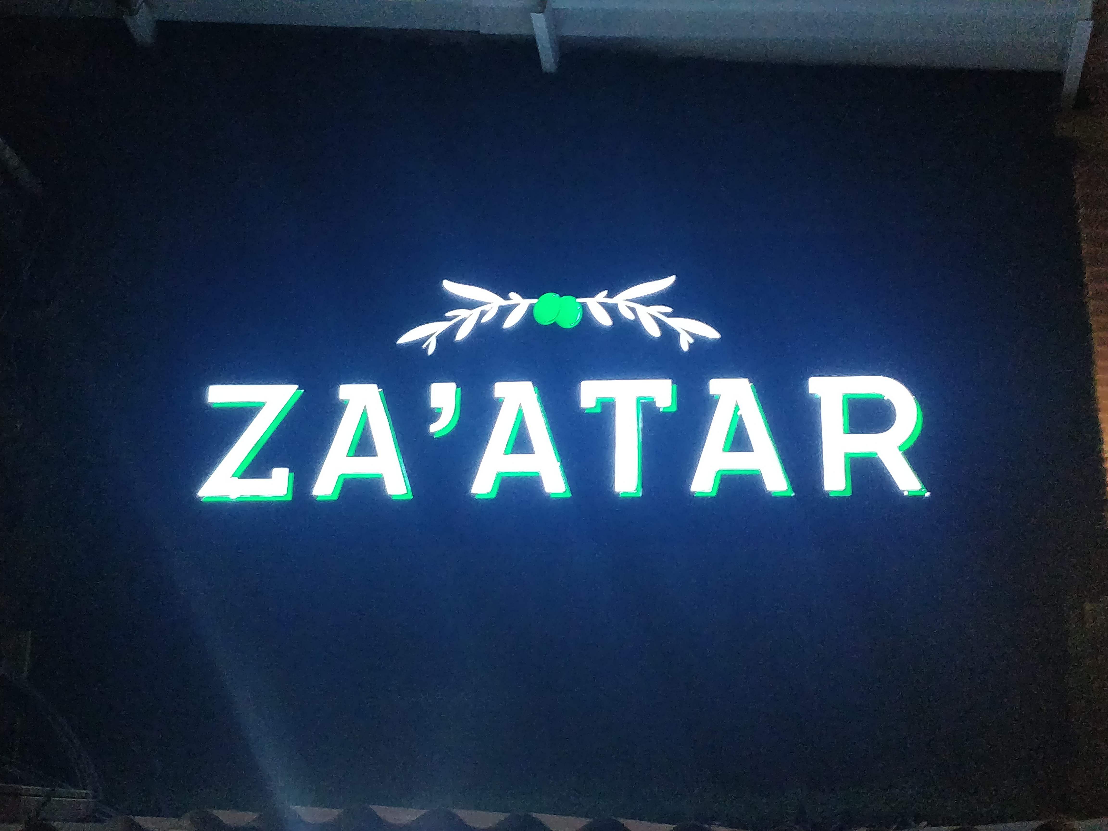 Green,Neon sign,Text,Signage,Font,Neon,Display device,Electronic signage,Technology,Logo