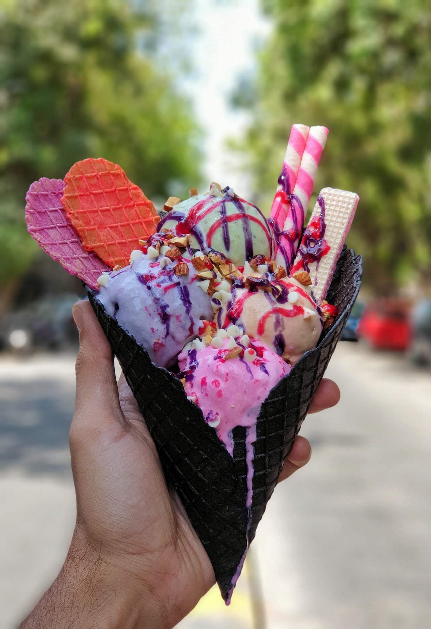 Ice cream cone,Frozen dessert,Pink,Ice cream,Gelato,Food,Dessert,Hand,Plant,Cuisine