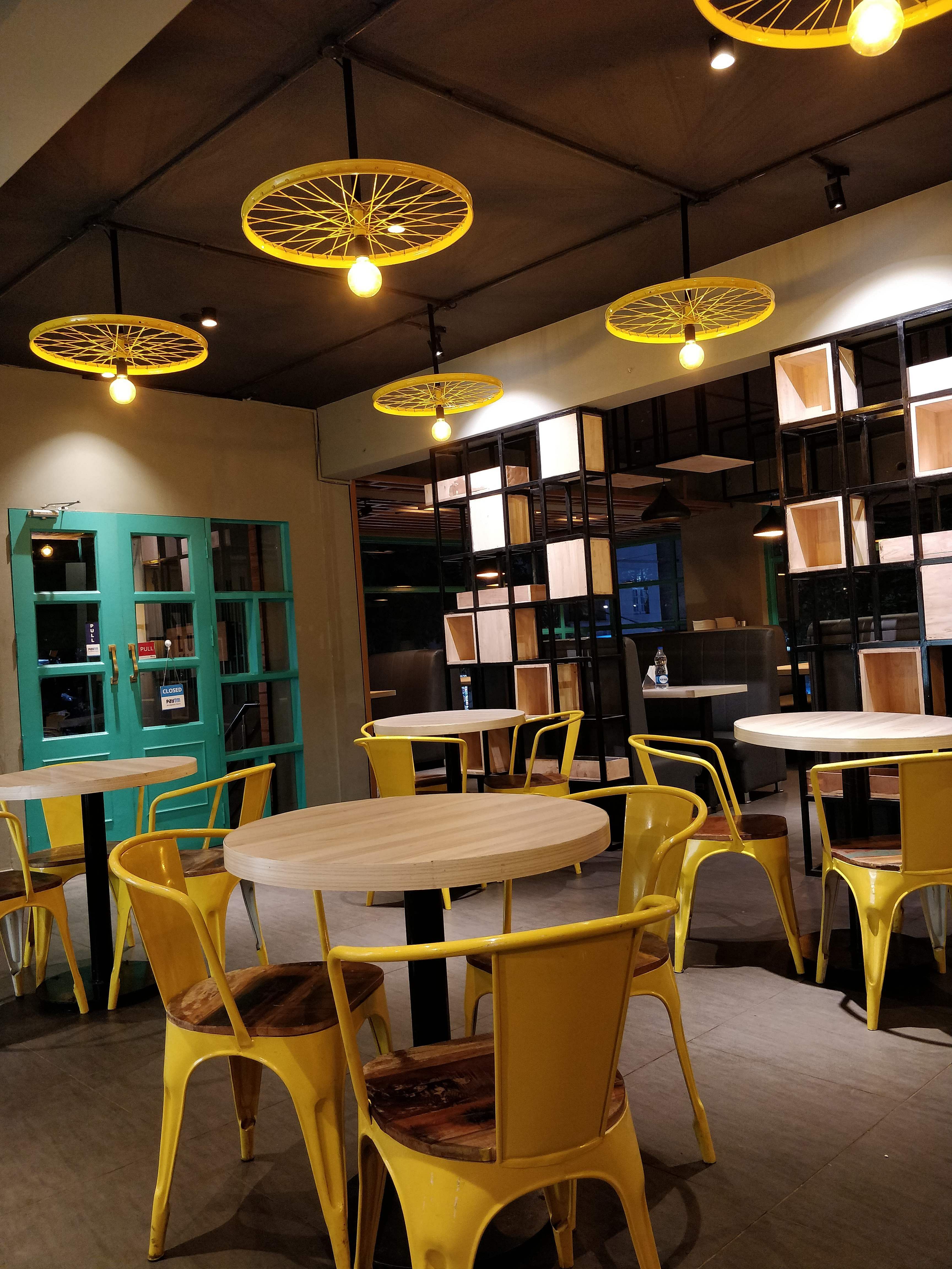 Building,Room,Restaurant,Interior design,Lighting,Yellow,Table,Furniture,Café,Kitchen & dining room table