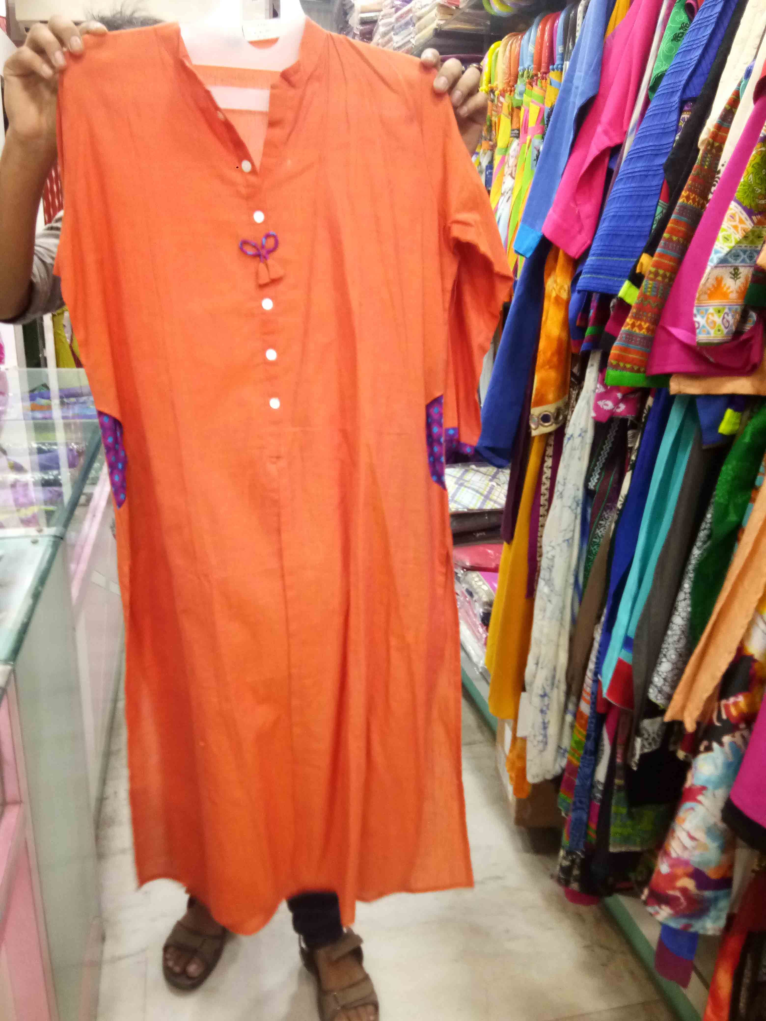 Clothing,Boutique,Orange,Peach,Dress,Textile,Formal wear,Fashion design,Outerwear,Bazaar