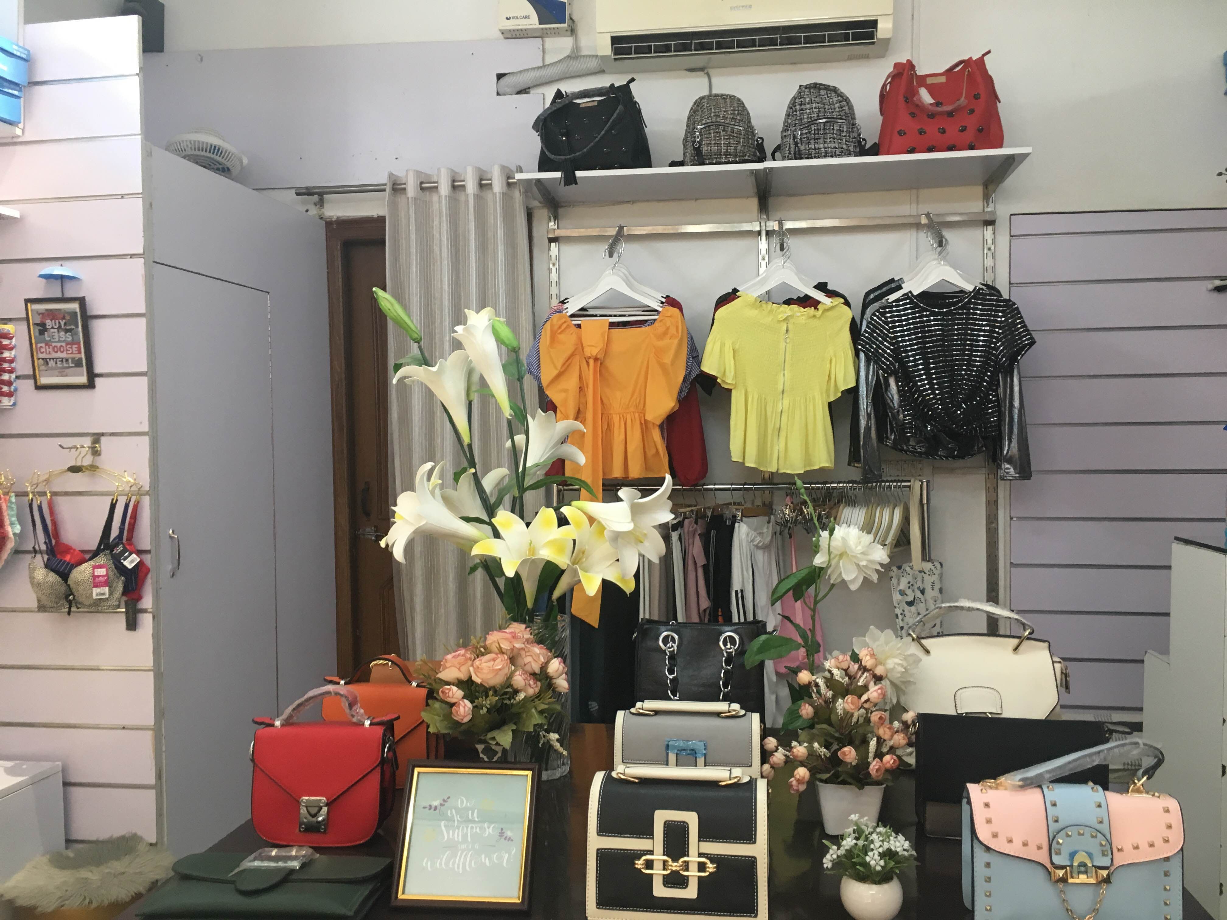 Room,Boutique,Interior design,Plant,Furniture,Shelf,Building,Fashion accessory,Flower,Window