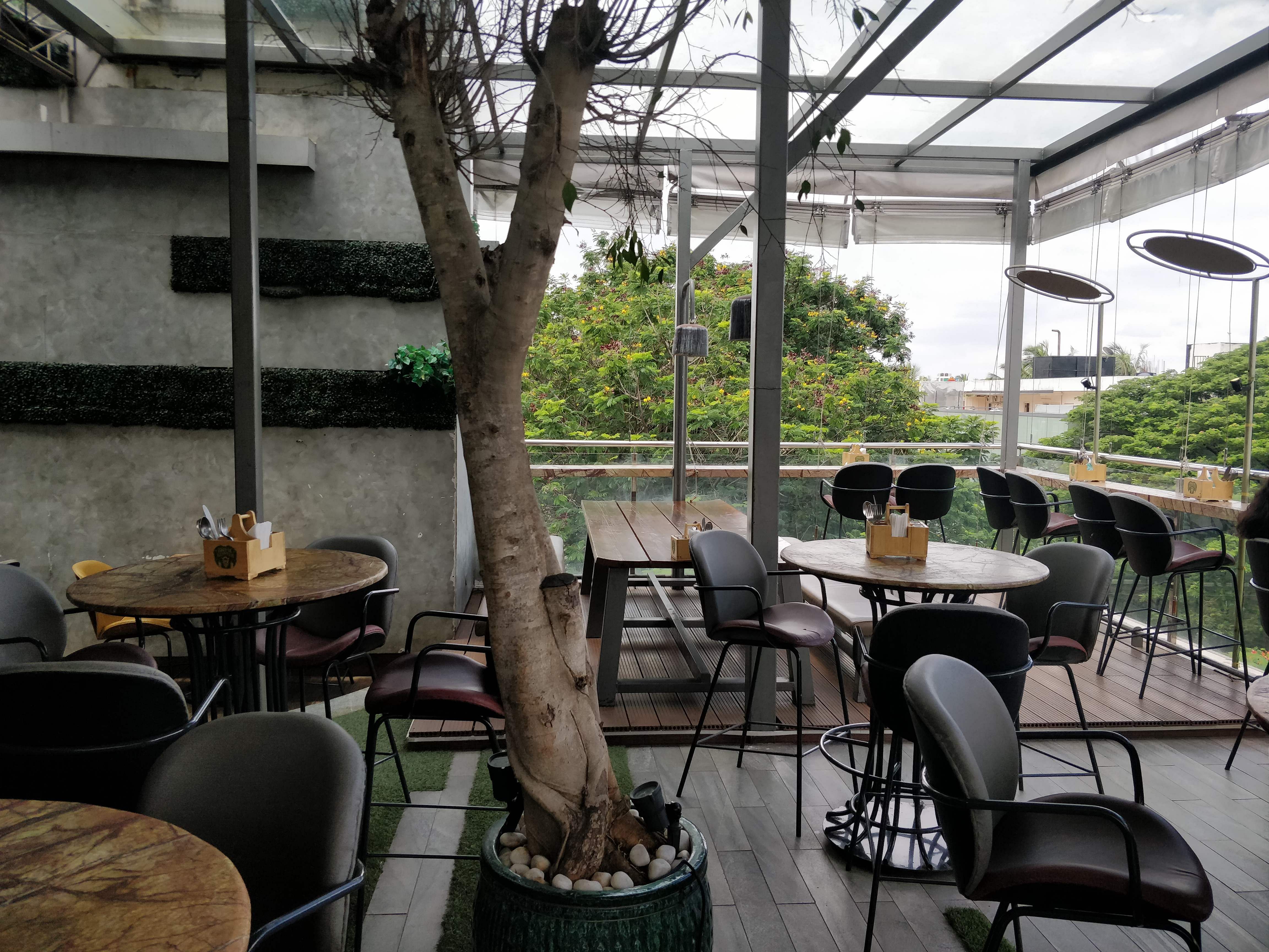 Restaurant,Tree,Building,Patio,Interior design,Coffeehouse,Room,Architecture,Table,Real estate