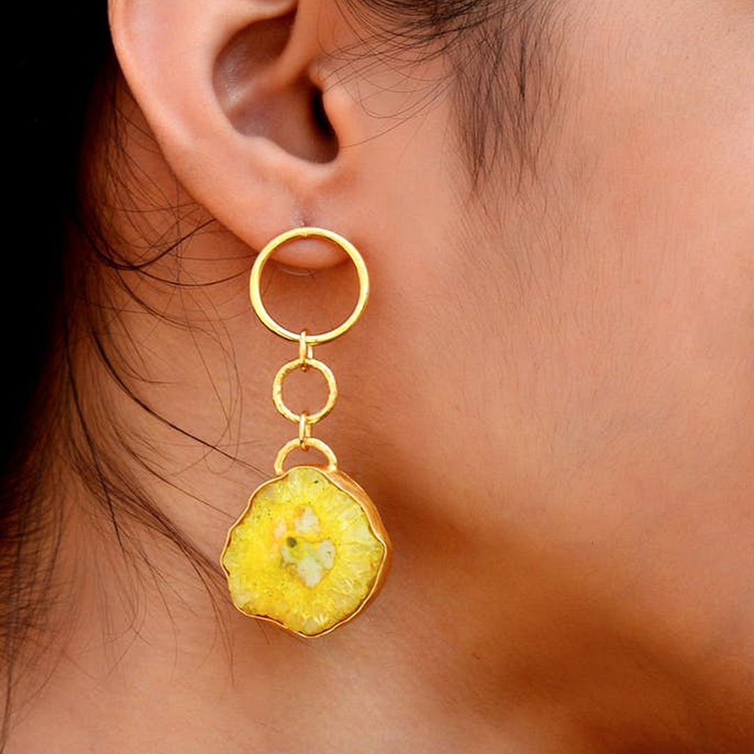 Yellow,Ear,Earrings,Jewellery,Fashion accessory,Chin,Organ,Body jewelry,Neck,Circle