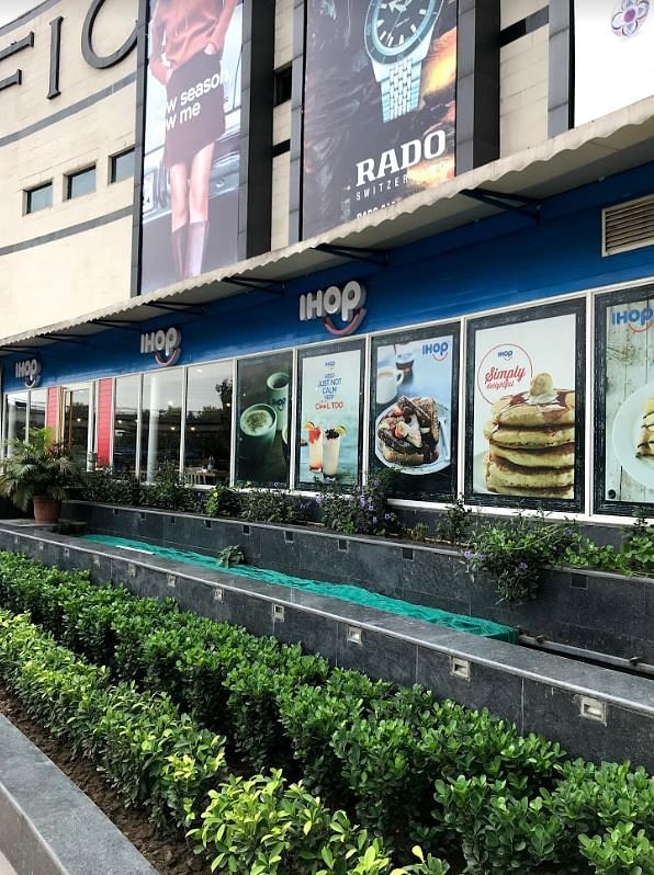 Building,Plant,Advertising,Vegetarian food,Signage,Facade,Mixed-use