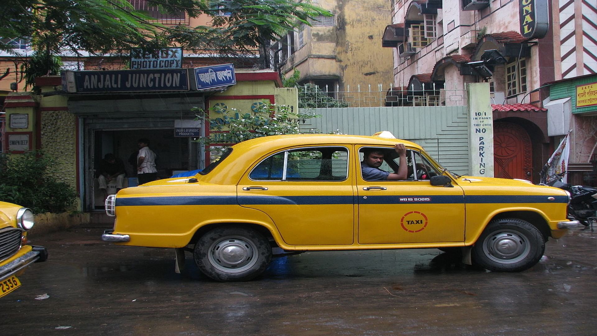 Land vehicle,Vehicle,Car,Regularity rally,Taxi,Yellow,Classic car,Hindustan ambassador,Sedan,Coupé