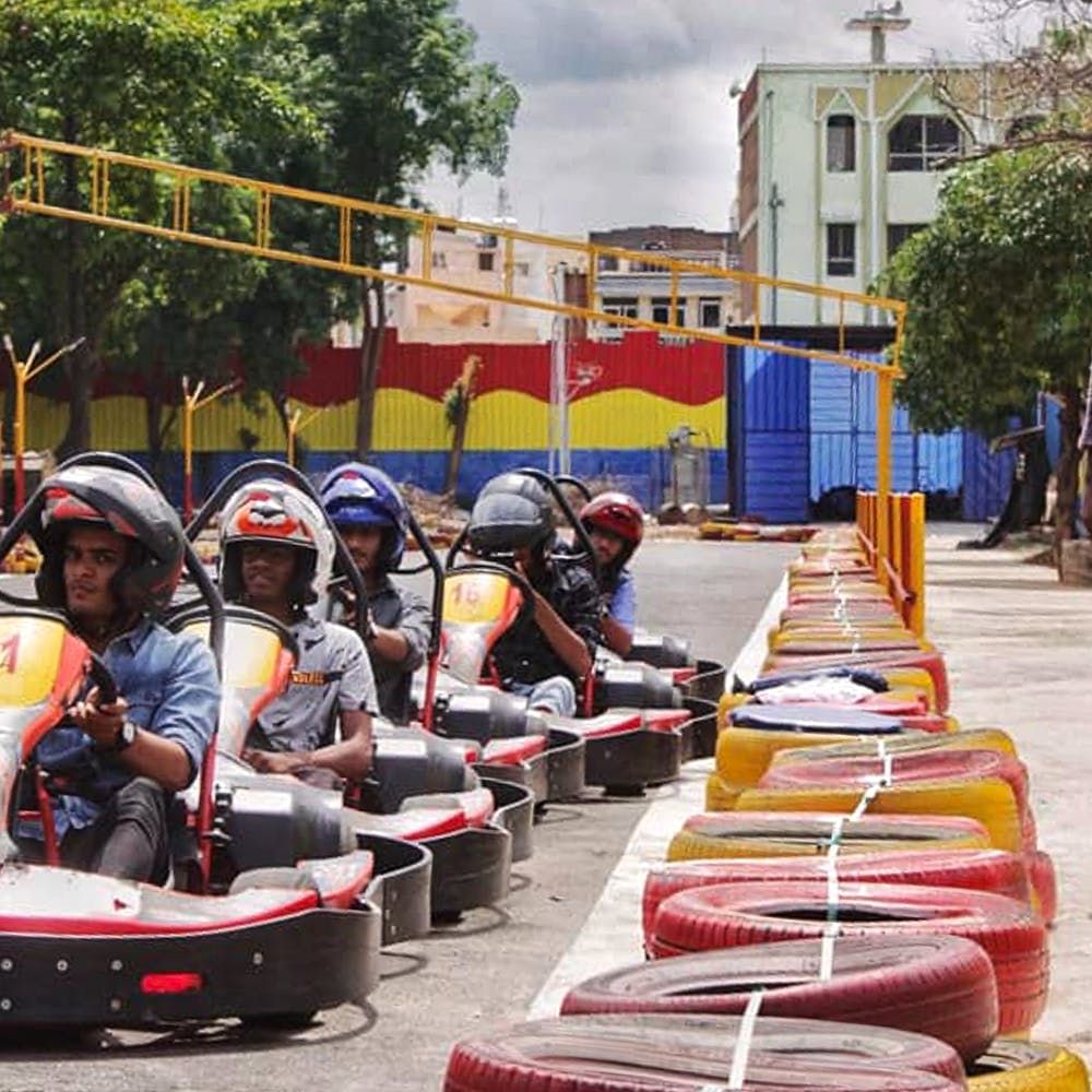 Public space,Recreation,Vehicle,Helmet,Tree,Headgear,Personal protective equipment,Tourism,Leisure,Amusement park