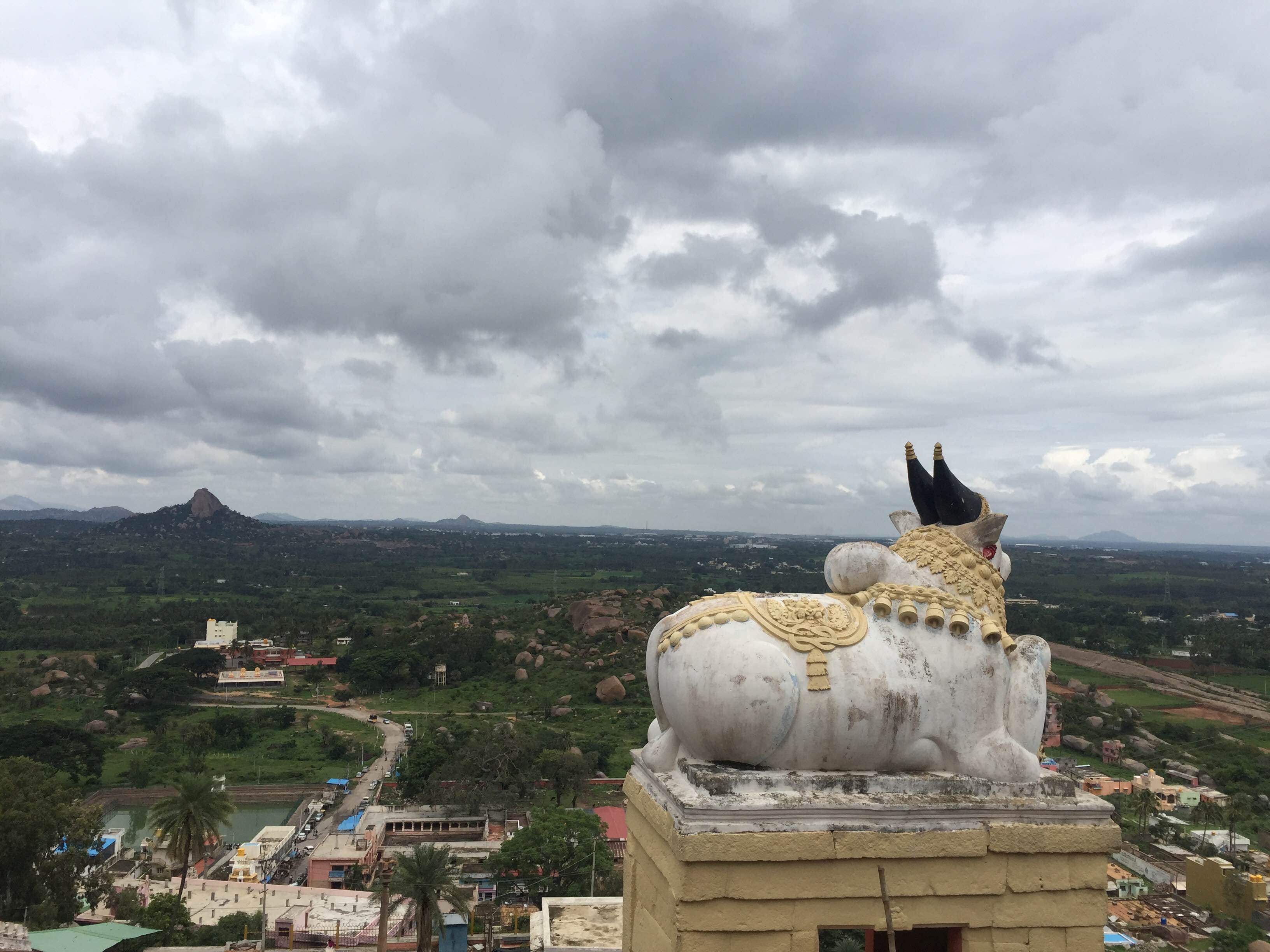 Sky,Cloud,Mountain,Temple,Tourism,Statue,Place of worship,Building,Historic site,Vacation