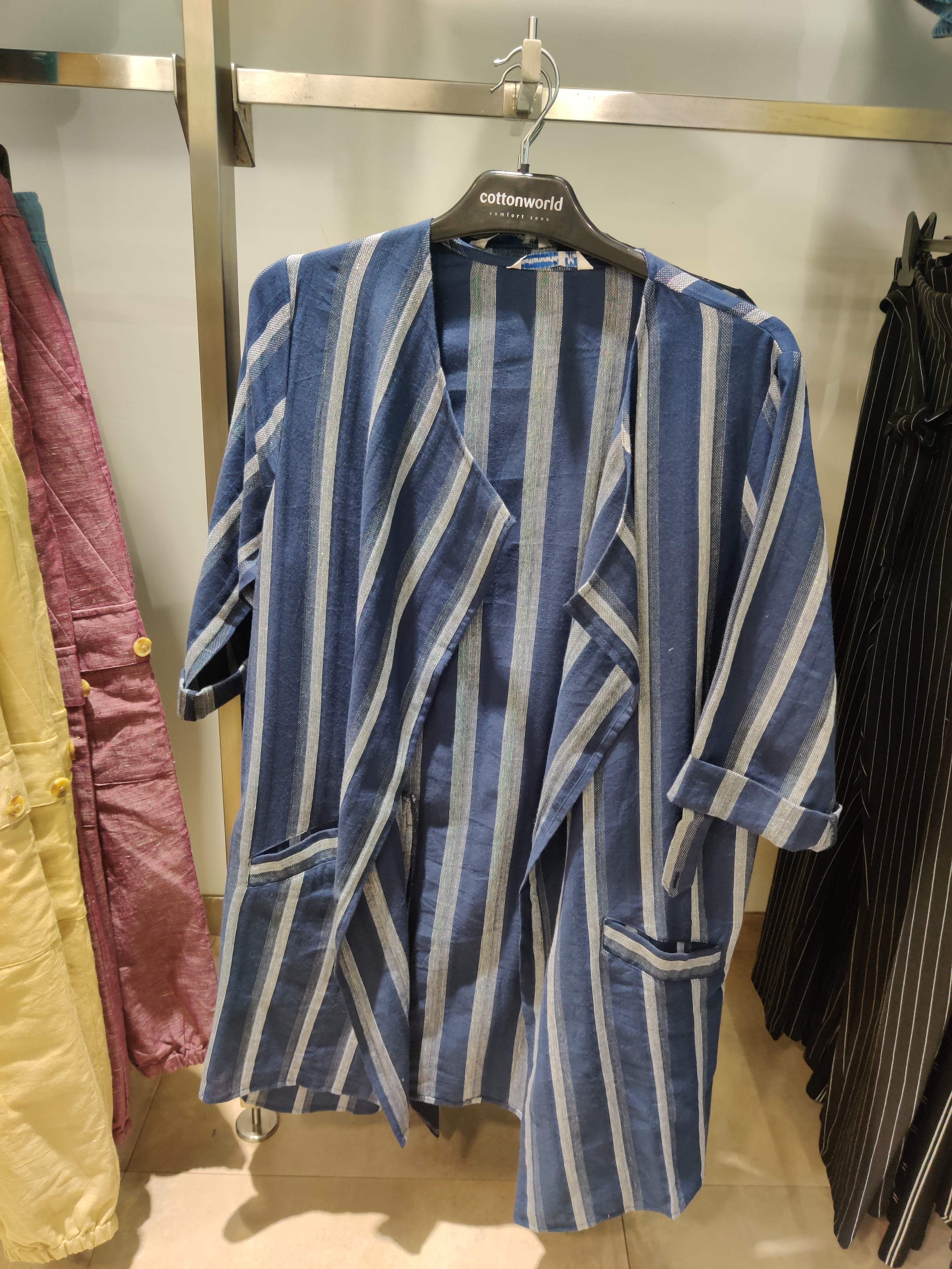 Clothing,Clothes hanger,Outerwear,Boutique,Sleeve,Technology,Room,Electronic device,Mobile phone,Jacket