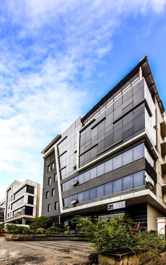 Architecture,Building,Daytime,Commercial building,Property,Mixed-use,Facade,Sky,Residential area,Corporate headquarters