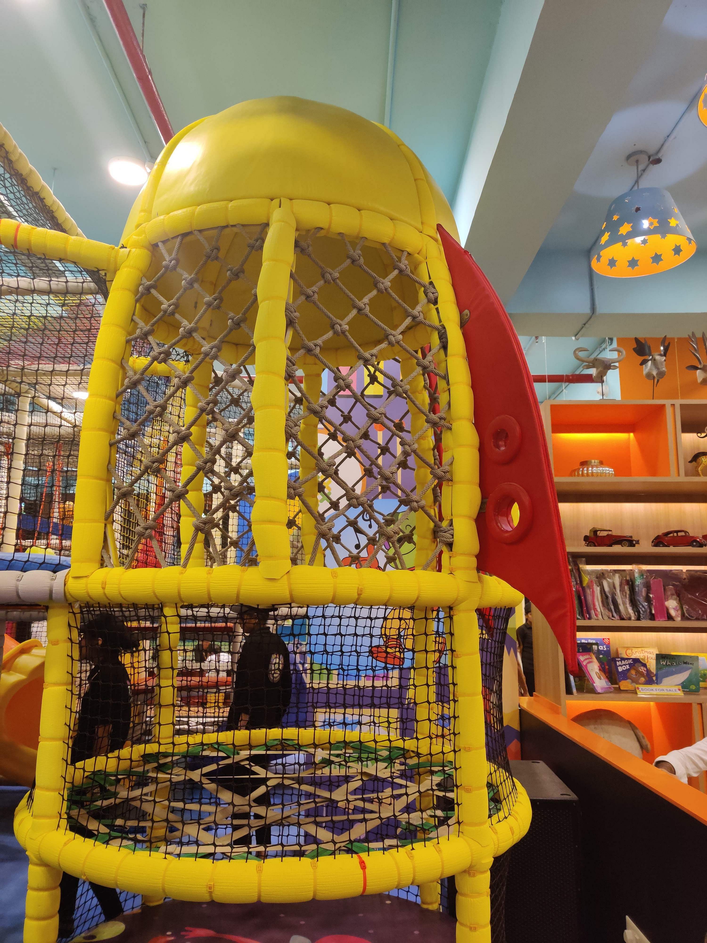 Cage,Yellow,Public space,Playground,Fun,Outdoor play equipment,Recreation,Supermarket,City,Play