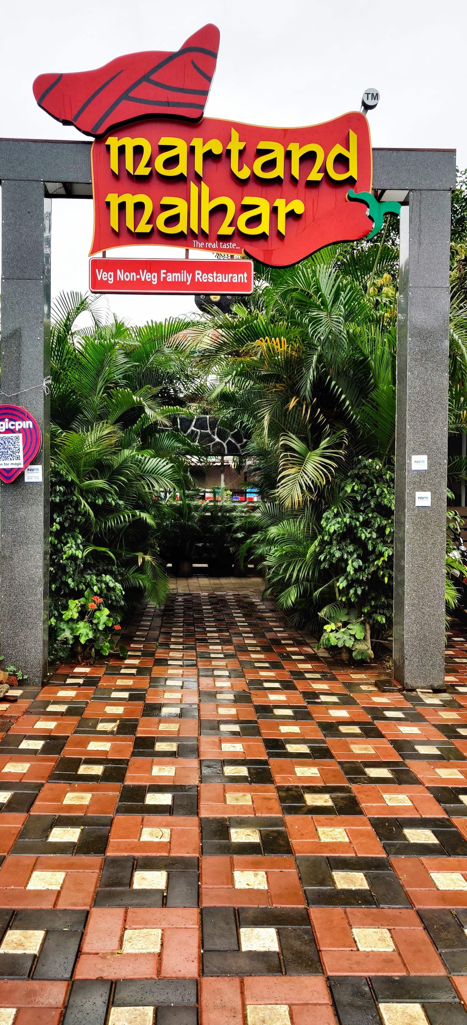 Flooring,Tree,Floor,Walkway,Tile,Plant,Building,Road surface,Botanical garden,Advertising