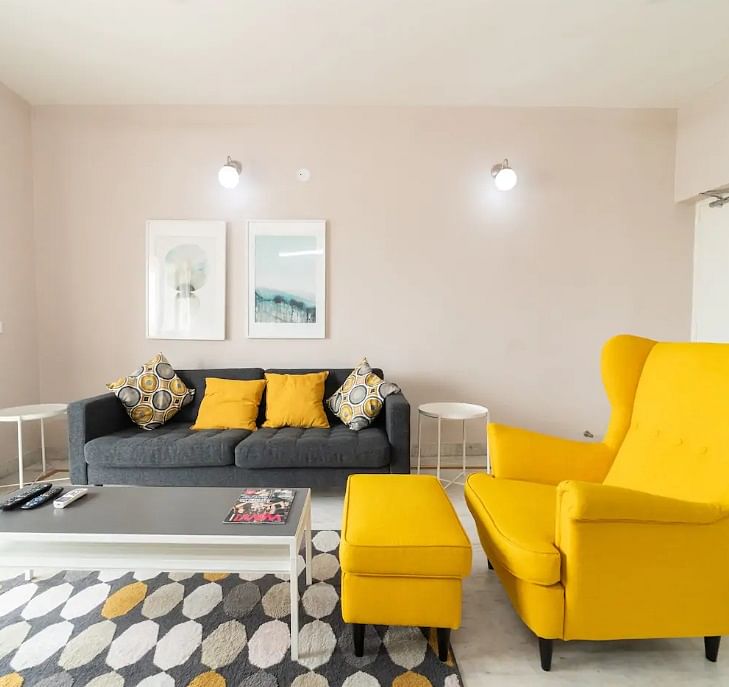 Living room,Furniture,Room,Yellow,Couch,Interior design,Property,Orange,Floor,Coffee table