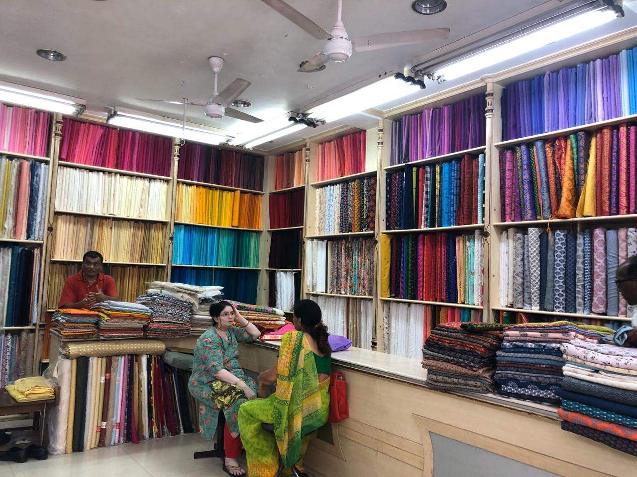 Building,Retail,Bookselling,Shelving,Textile,Library,Interior design,Room,Outlet store,Shelf