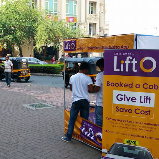 Yellow,Advertising,Transport,Vehicle,Street,Street performance,Pedestrian,Asphalt,Sidewalk,Road surface