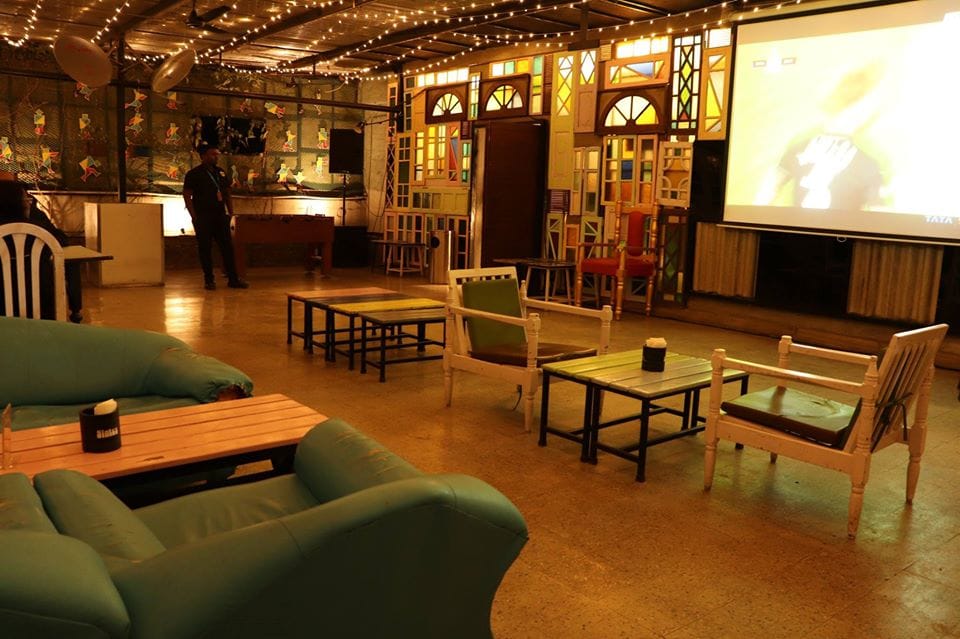 Room,Building,Interior design,Living room,Furniture,Table,Floor,Lobby,Flooring,Loft